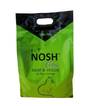 An adult tabby cat sitting beside a Pet Nosh Cat Food Plus bag labeled “Meat & Veggie,” with a bowl full of colorful kibble on a pastel Reem Pet Store background.