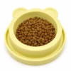 Yellow bear-shaped anti-ant cat bowl filled with dry cat food
