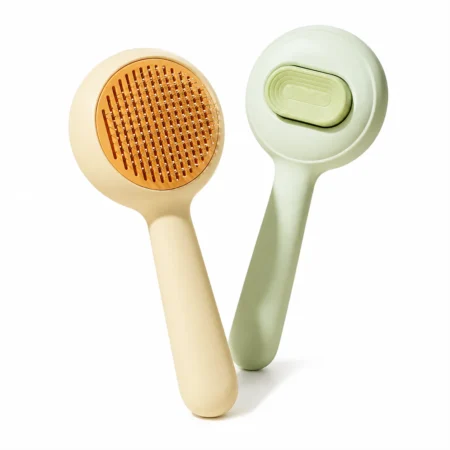 Round self-cleaning slicker brush for cats and dogs shown from front and back.