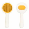 Orange round self-cleaning slicker brush for cats and dogs, front and back view.