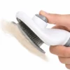 Self-cleaning slicker brush releasing collected pet fur with one-click button.