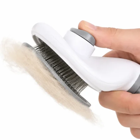 Self-cleaning slicker brush releasing collected pet fur with one-click button.